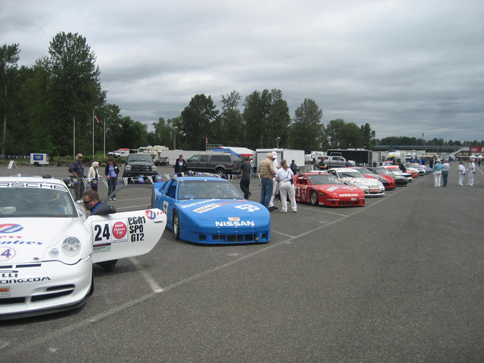 continuation of the long line of racing cars in pre-grid formation