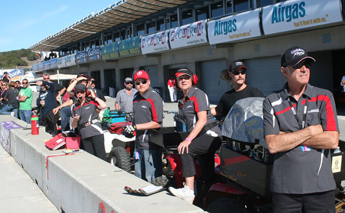 Pit crew looking over the pit wall at laguna runoffs
