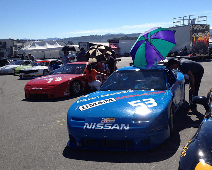 umbrellas out protecting from the hot sun during qualifying nissan 240sx blue #53 and red #73